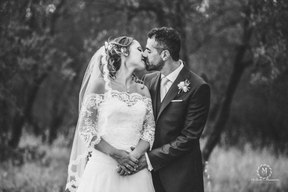 bride and groom kiss each other happy on their wedding day in tuscany