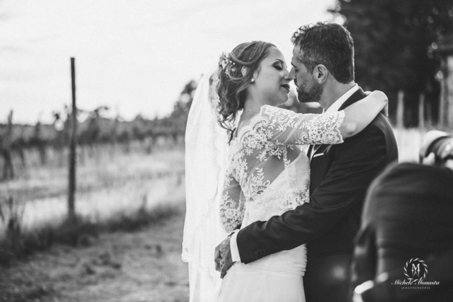 bride and groom kiss each other happy on their wedding day in tuscany