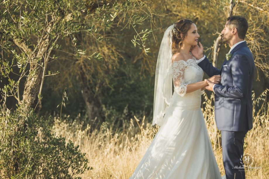 Beautiful bride caress groom in Tuscany coutriside