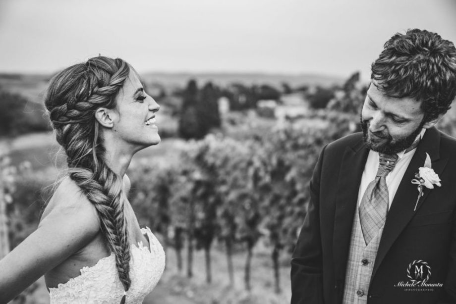 bride smiles at groom in a natural moment during the shooting the day of the wedding in tuscany