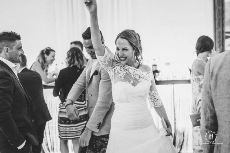 Happy bride dancing during her Wedding party in Tuscany